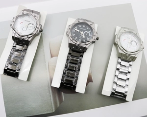 Three men's quartz watches with octagonal bezels and stainless steel link bracelets