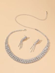 Detail of luxury copper bridal jewelry set with sparkling rhinestones on beige background
