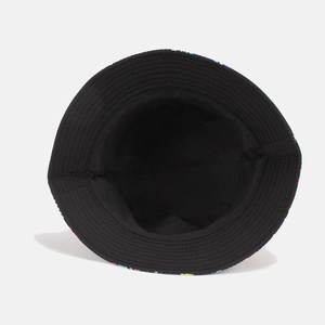 Top-down view of black canvas bucket hat showing colorful geometric lining and cotton interior
