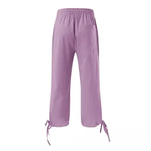 Detail view of high waist elastic band and back pocket on light purple linen cotton pants