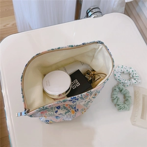 Macro view of floral cotton makeup bag with spacious interior and zipper closure