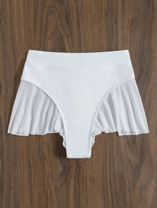 Detail of white high-waisted bikini bottom with mesh ruffles on deep wood background