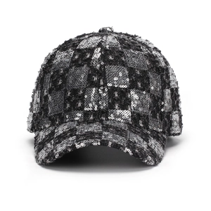 Detail of sequined checkerboard pattern and tweed fabric on a baseball cap