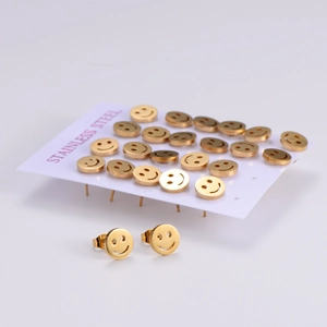 Golden stainless steel smiley face stud earring set displayed on a white product card
