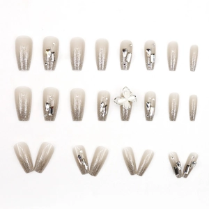 Sparkling gradient press-on nails with 3D butterfly and rhinestone accents in coffin shape