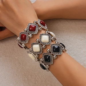 Detail of vintage bohemian elastic bracelet with red and black acrylic stones