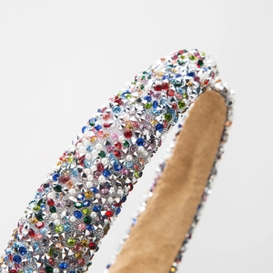 Luxurious padded headband with colorful rhinestones, pearls and silver studs on brown suede