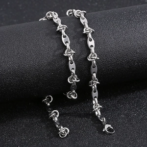 Detailed view of silver titanium steel coffee bean chain with glossy lobster clasp