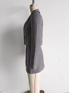 Vue détaillée de la texture du tissu pied-de-poule et du revers de l'ensemble tailleur
