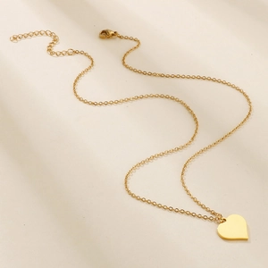 Polished gold heart pendant necklace on minimalist chain with lobster clasp and extension
