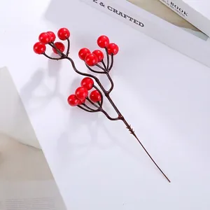 Macro shot of vibrant red artificial holly berries with glossy finish for festive home decor