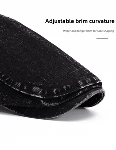 Detail of distressed black denim beret with wide foldable brim for face framing