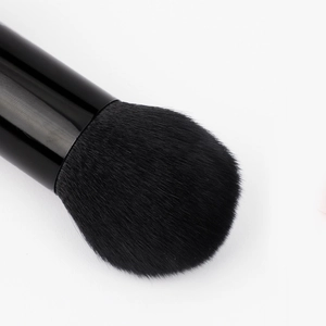 Dual-head makeup brush with dense black synthetic bristles and a sleek black handle