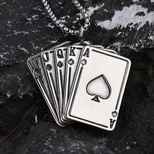 Royal flush spade poker card pendant in silver stainless steel on a dark rock background