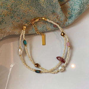 Detail of double-layer bracelet with freshwater pearls and colorful natural stones