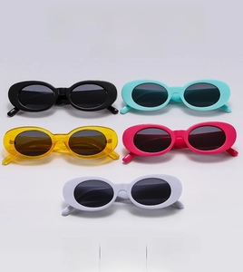 Flat lay of vintage oval sunglasses in black blue yellow pink and white color options