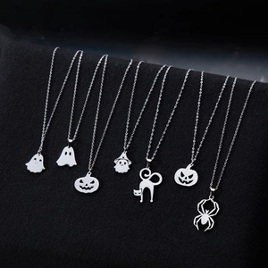 Set of eight stainless steel Halloween necklaces with ghost and pumpkin charms on a black display