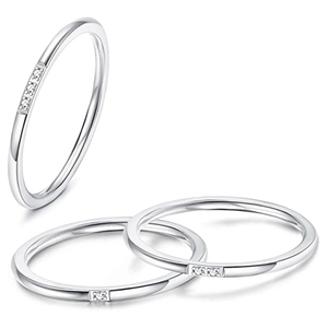 Detail of silver stackable rings with micro-inlaid cubic zirconia and thin round band