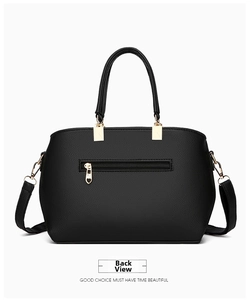 Detail view of the bag back featuring a functional zipper pocket and heart shaped puller