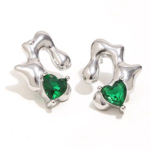 Modern irregular silver fluid heart earrings with green gemstones on white background