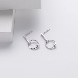 Macro shot of S925 sterling silver geometric hoop earrings with polished metal finish