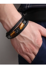Detail of men's multilayer leather bracelet with tiger eye stone and magnetic clasp