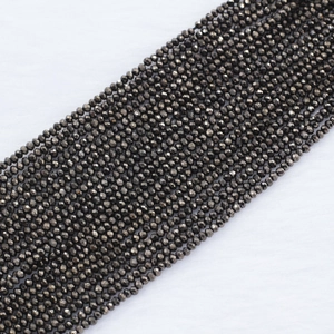 Macro view of 2mm dark grey faceted crystal beads with metallic finish for jewelry making