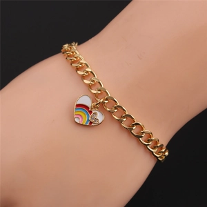 Close-up of gold Cuban chain bracelet with heart-shaped rainbow enamel charm and zircons