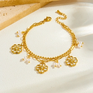 Golden double-layer bracelet featuring white camellia flower pendant and faux pearls