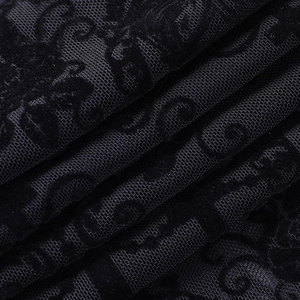 Detailed macro view of black lace fabric featuring velvet floral motifs and mesh texture