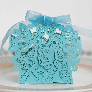 Close-up of light blue laser-cut butterfly candy box with organza ribbon detail