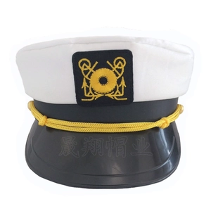 Close-up of white sailor captain hat with golden anchor embroidery and braided rope decor