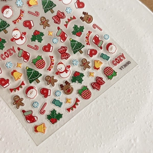 Christmas nail stickers with tree, reindeer, and gingerbread man patterns on white background