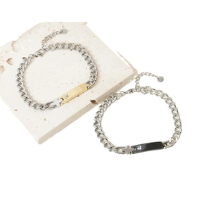 Couples stainless steel cross bracelets with zircon inlay on polished beige stone