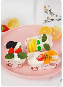 Detailed view of artificial fruit cupcake model with strawberries and blueberries in a pink tray