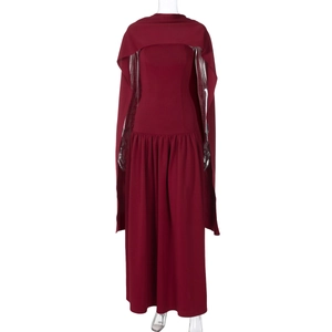 Detail of burgundy backless maxi dress with matching capelet and waist pleats
