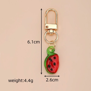Detailed view of handmade watermelon fruit keychain with dimensions and weight specs