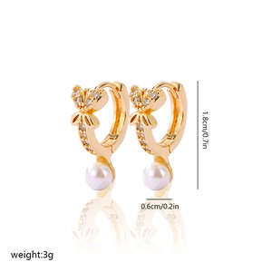 Detail of gold butterfly earrings with pearls and cubic zirconia stones, dimensions 1.8cm