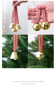 Detail of red plaid ribbon and golden metal bells hanging as Christmas tree decorations
