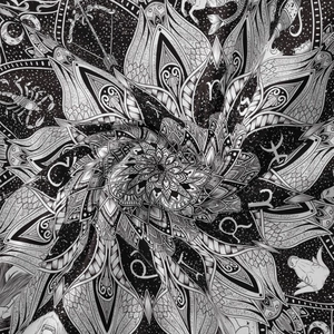 Detailed close-up of monochrome mandala and zodiac moon phase tapestry fabric texture