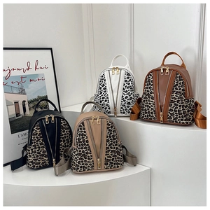 Mini leopard print backpacks in black, beige, white, and brown with gold dual zippers