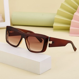 Fashion cat eye sunglasses with brown gradient lenses on a minimalist pedestal