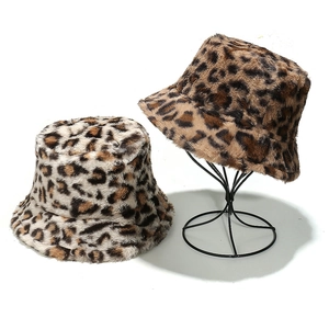 Detail of leopard print faux fur bucket hats in beige and brown on display stands