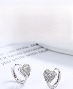Close-up of S925 sterling silver heart-shaped earrings with shimmering pave crystals