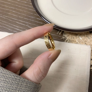 Macro shot of gold-plated titanium ring with textured dragon scale pattern