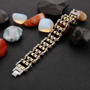 Detailed macro view of dual-tone gold and silver mechanical bike chain bracelet
