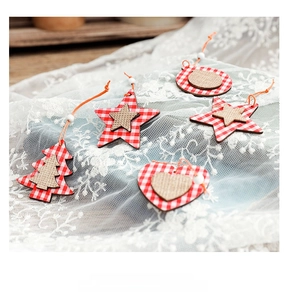 Close-up of wooden Christmas ornaments with red plaid patterns and jute on white lace