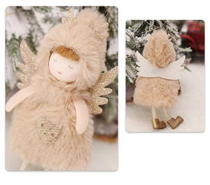 Detail of plush Christmas angel doll with golden reindeer antlers and wings on a snowy tree