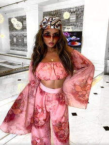 Front view of floral chiffon two-piece set featuring off-shoulder top and wide-leg trousers