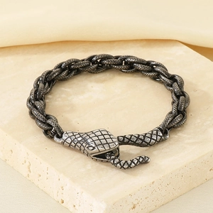Close-up of vintage silver snake head buckle on thick twisted chain bracelet